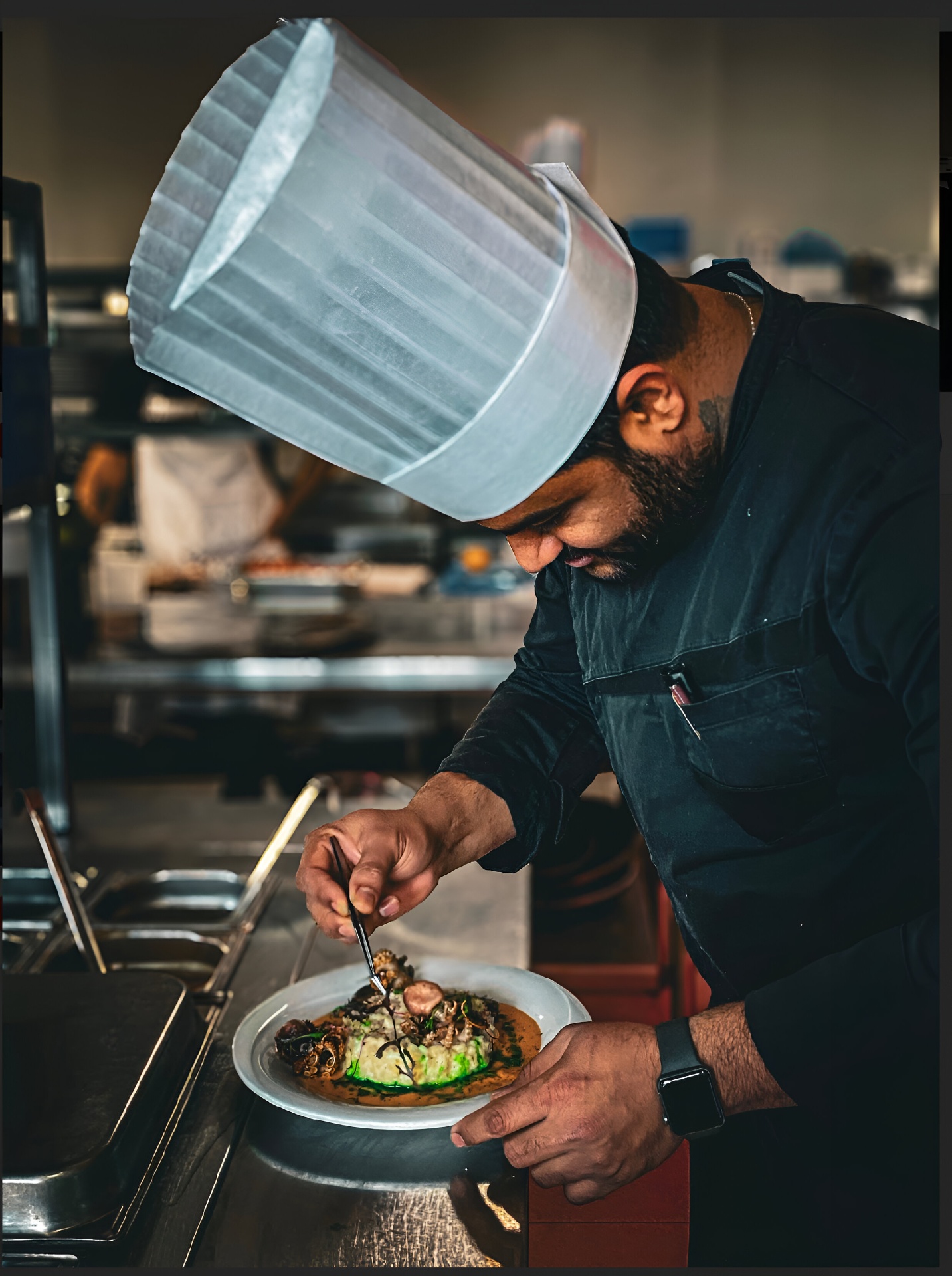 Chef Venu plating a dish